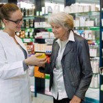 Pharmacist advising medication to senior patient.